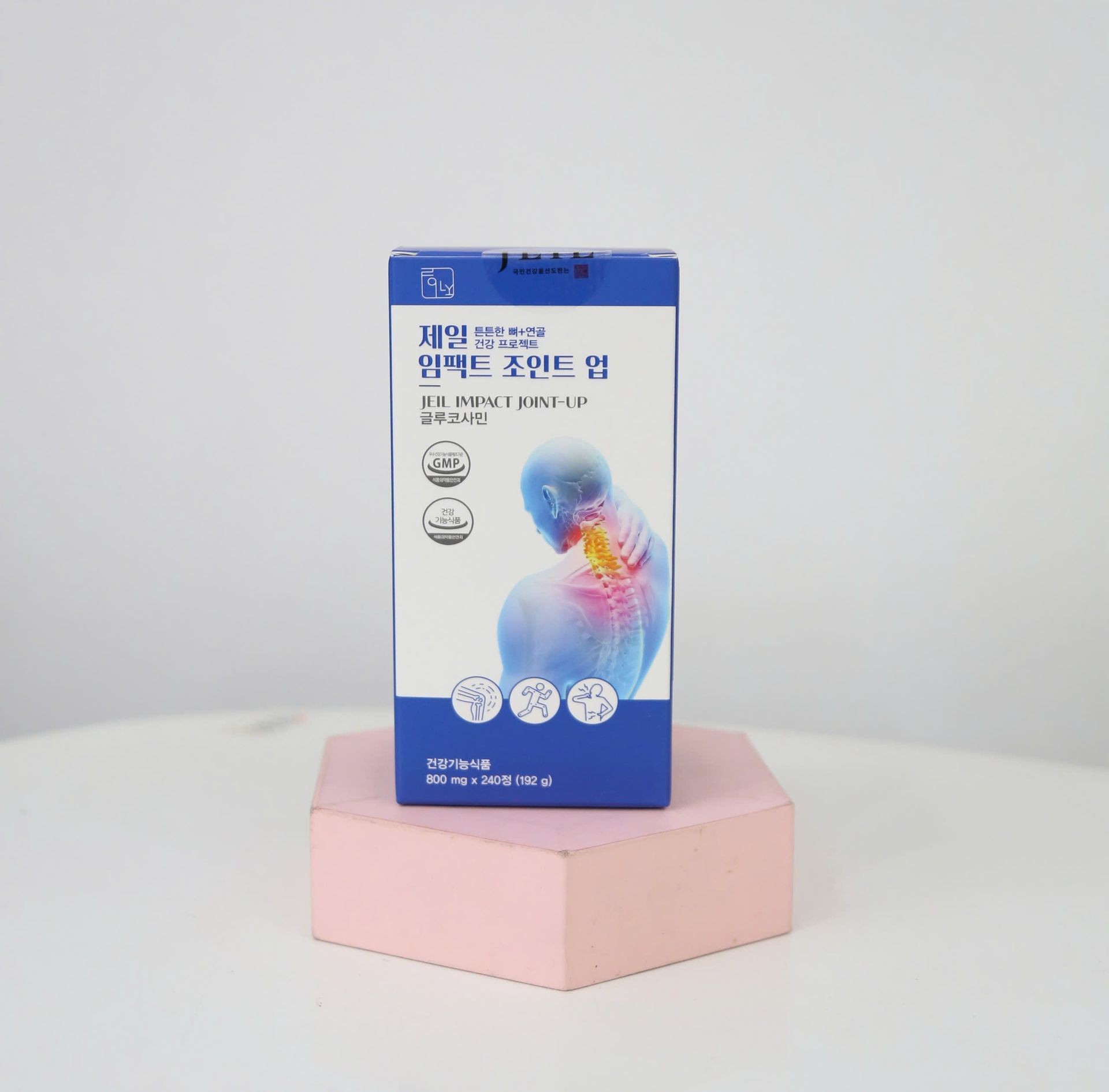 Box of Jeil Impact Joint-Up dietary supplement displayed on a pink hexagonal stand.