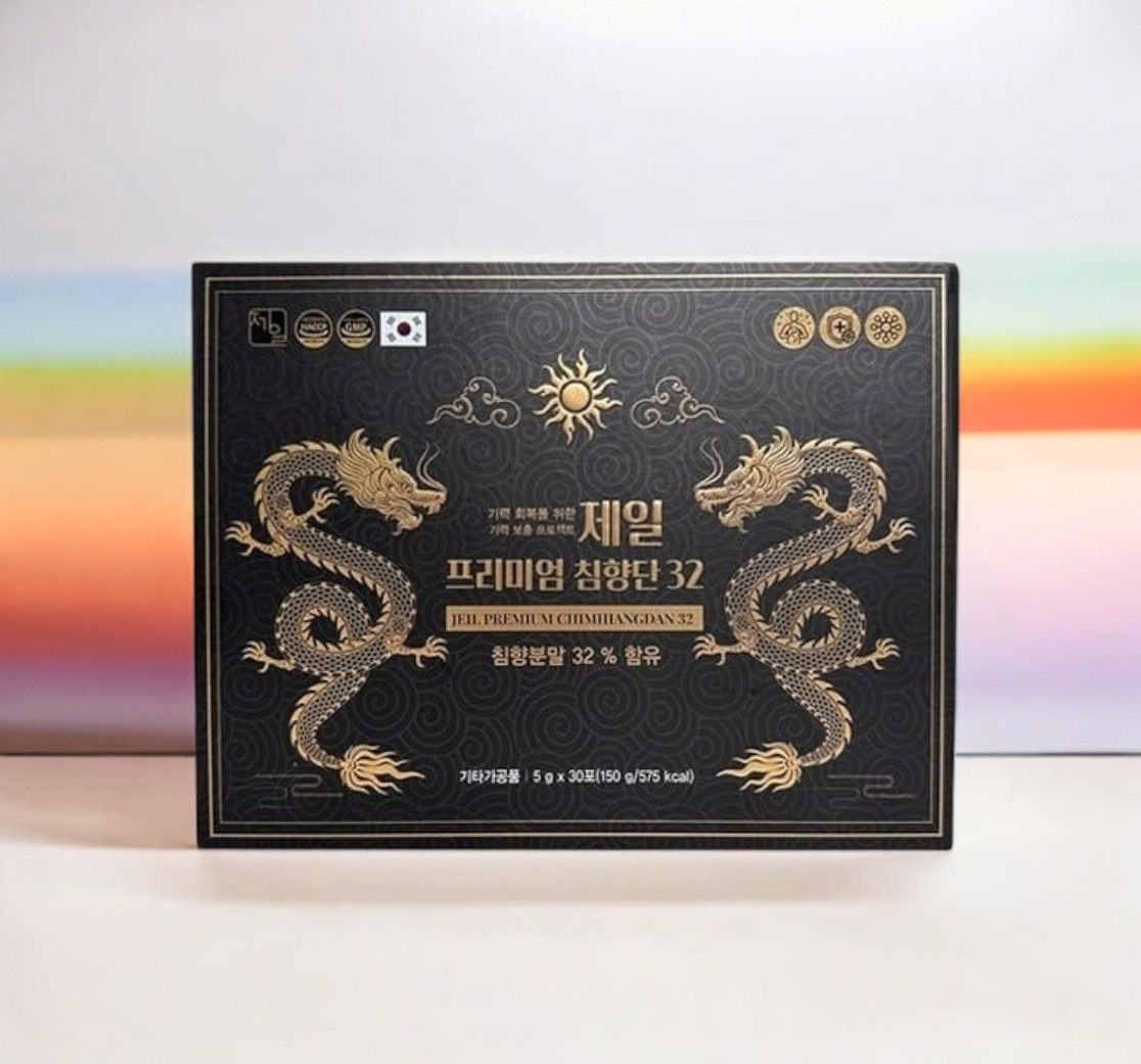 Black packaging box with golden dragon designs and Korean text, featuring a sun emblem.