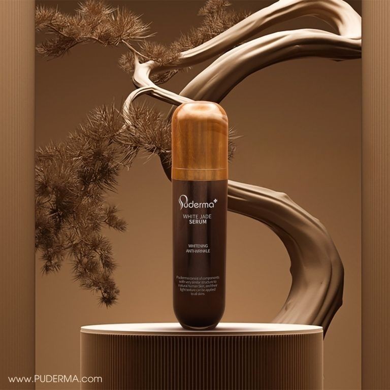 Poderm White Jade Serum bottle displayed on a podium with an artistic tree branch backdrop.