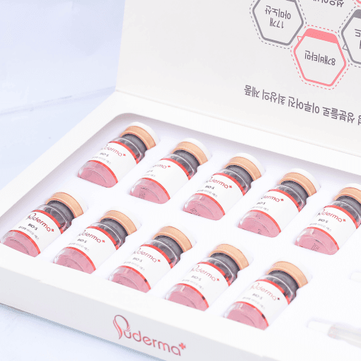 Open box containing ten small vials labeled 'Puderma+', arranged neatly in a row.