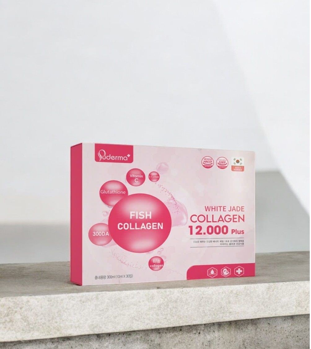 Box of fish collagen supplement with pink design and text on a white background.