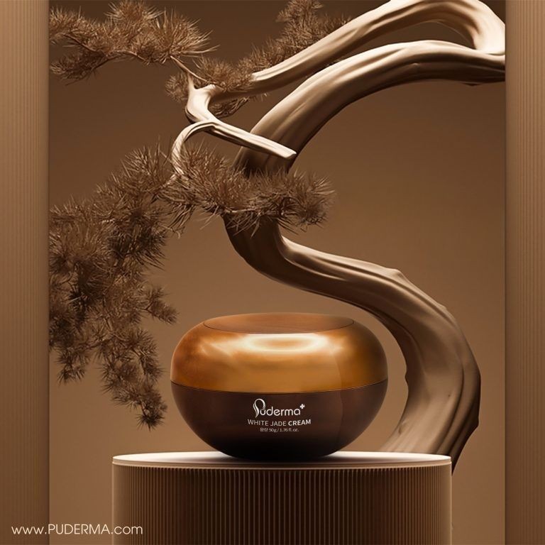 Luxurious cream jar displayed on a pedestal with an elegant tree branch in the background.